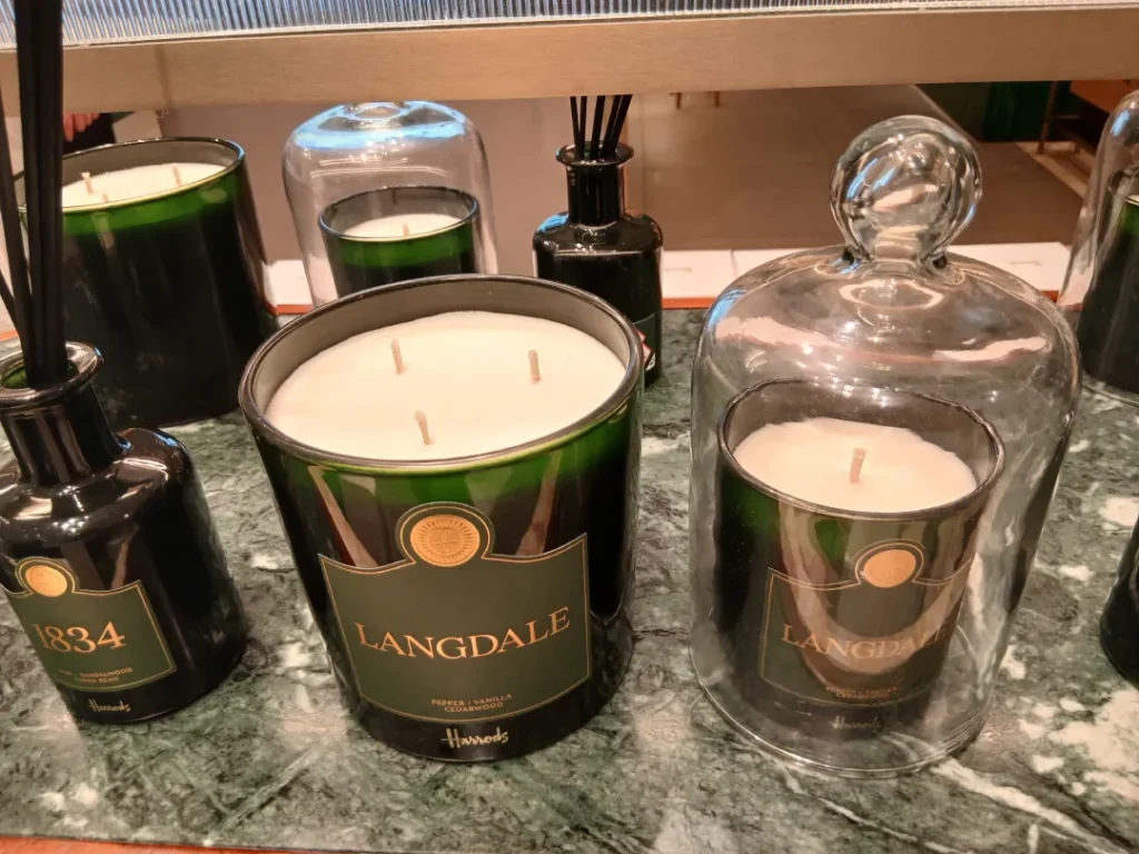Harrods 2026 luxury candle collection on a marble and brass display in the Fragrance Parlour.