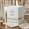 With Love luxury candle and gold-detailed gift box in a bridal boutique.