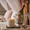 Lit With Love luxury candle next to champagne in a romantic bridal suite.