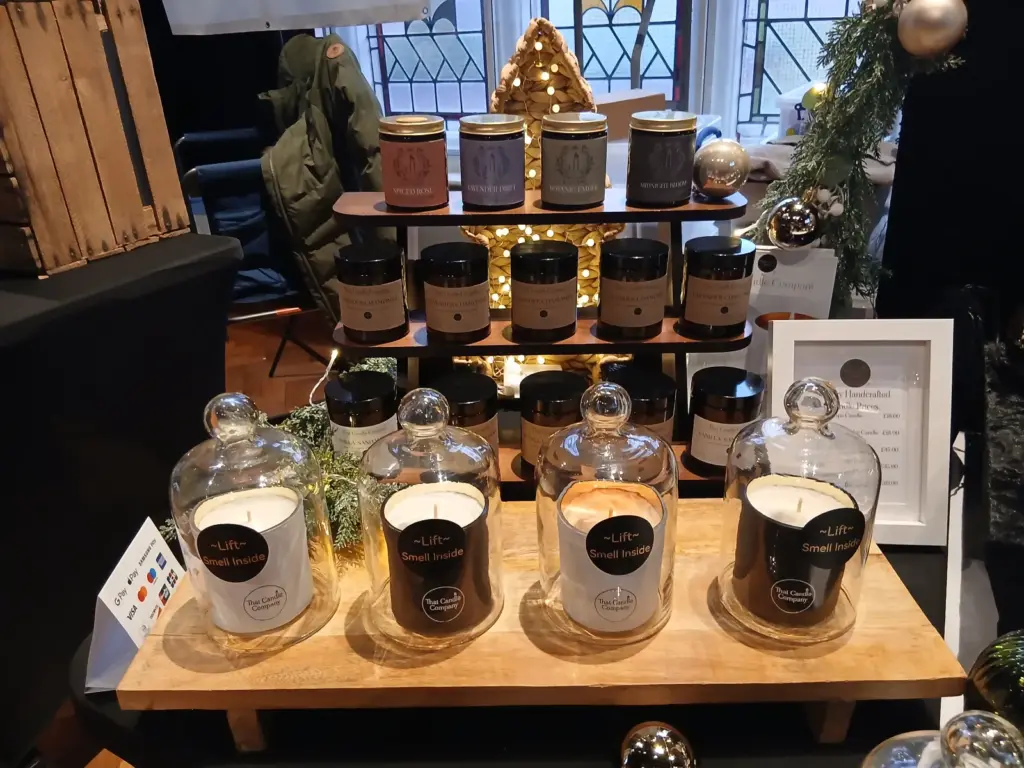Scented candle fragrance testing station with glass cloches and Lift Smell Inside signs